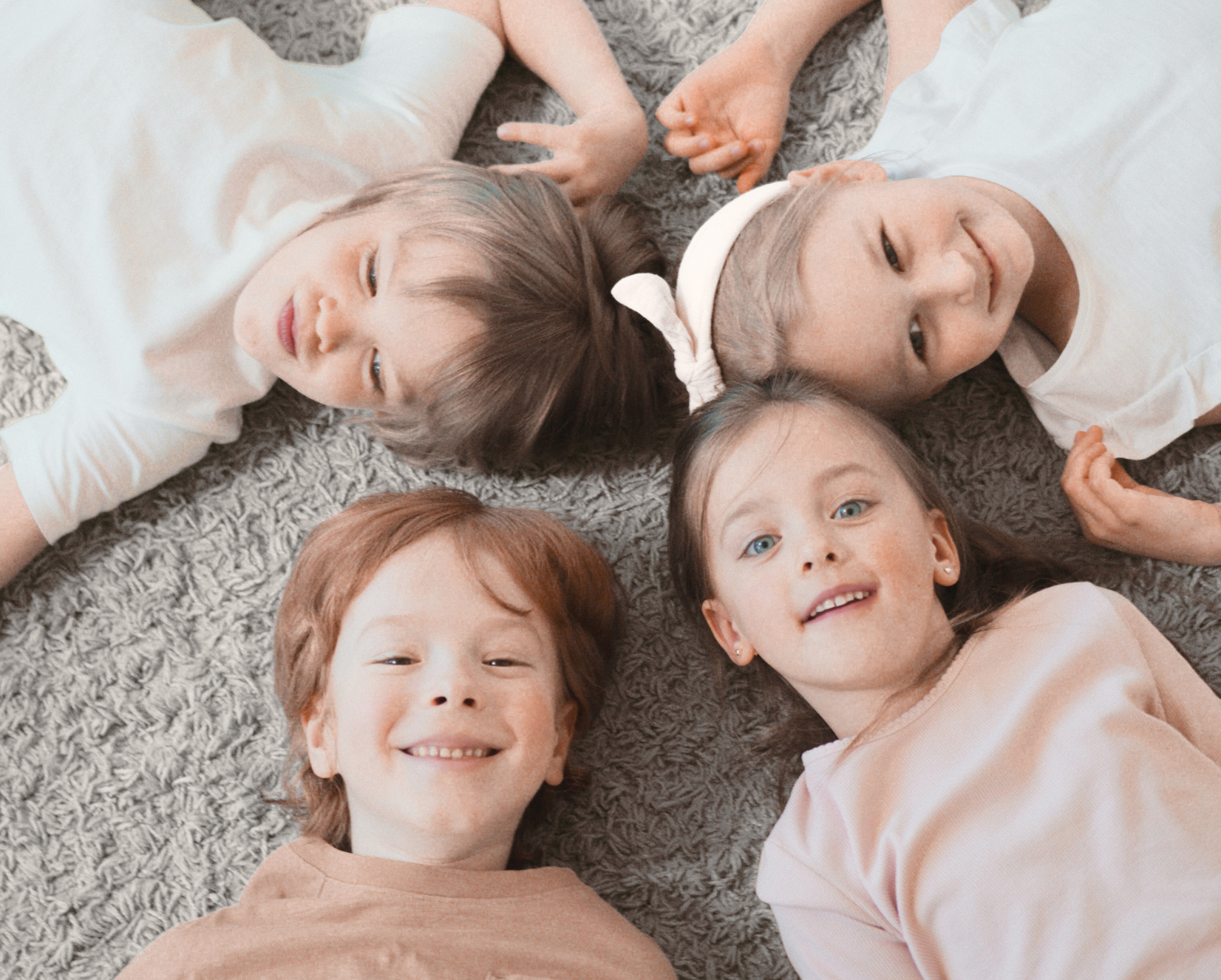 Collage of a baby's foot, a baby lying on a blanket, and four children lying on the floor.